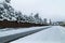 Winter landscape road and brick sidewalk pavement.