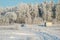 Winter landscape with road at countryside. Snow on a field and frosty forest. Idyllic winter panorama view. Car driving.