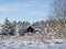 Winter landscape scene with wood lodge house between snowy pine trees covered with a lot of snow in winter. Beautiful winter