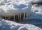 Winter landscape by the sea, snowy, interesting ice shapes on the sea shore, dunes covered with a white layer of shining snow