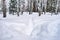 Winter landscape in Siberia, a deep trail in fresh snow on a snow-covered alley in a city park.