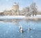 Winter landscape with snow, castle and swans