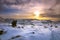 Winter landscape with snow, clouds and sunset.