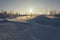 Winter landscape, snow-covered desert forest-tundra in the rays of the setting sun