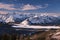 Winter landscape with snow covered mountains and frozen lake.