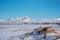 Winter Landscape, sow field with frozen lake and snow mountain with clear blue sky