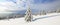 Winter landscape. Spectacular panorama is opened on mountains, trees covered with white snow, lawn and blue sky with clouds