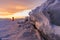 Winter landscape in sunset, Cracked frozen ice of lake covered by snow at lake Baikal, Russia in sunset