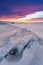 Winter landscape in sunset, Cracked frozen lake covered of snow at lake Baikal in Russia with beautiful sunset sky