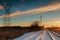 Winter landscape transmission line on of bright red sunset
