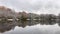 winter landscape, trees dusted with snow reflected in the mirror surface of the river