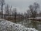 Winter landscape of Ukrina river, snowy banks and naked trees in riparian zone