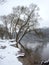 Winter landscape with white frost on trees near river