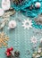 Winter lifestyle background with blue blanket, cup of cappuccino and various Christmas decoration. Top view. Frame