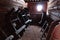 Winter light shining through small window on storage room with historical wooden sleds used as front part of horse carriage wagons