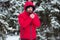 Winter male portrait. Young bearded man trying to heat his cold hands in frost winter park. Cold season concept