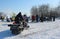 in winter, a man rides a snowmobile with transport in Siberia, viewers watch