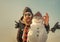 Winter man with snowman in pilot hat. Christmas man with beard on happy face. Snowman pilot, winter holiday celebration.