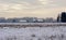 Winter marsh and forest landscape with old farm in evenng light