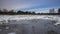 Winter meadows with snow and frozen puddle