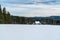 Winter Moravskoslezske Beskydy mountains in Czech republic with isolated house, snow covered meadow, forest and hills on the