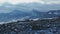 Winter morning jogging along the trail against the backdrop of a snow covered mountain range. Aerial view