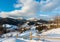 Winter morning mountain village outskirts and alp ridge