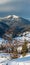 Winter morning mountain village outskirts and alp ridge