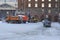 Winter morning tractor loads snow in a dump truck