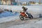 Winter motocross, rider on bike is accelerating