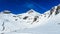 Winter mountain landscape with mountains and blue sky.