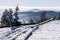 Winter mountain panorama with snow covered road from Lysa hora hill in Moravskoslezske Beskydy mountains in Czech republic