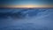 Winter mountain at sunset over clouds - time lapse video