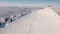 Winter mountain trail with tourist on top of the snowy hill with beautiful view of misty nature Outdoor background