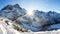 Winter mountains. Alpine winter nature landscape. Snowy mountain with bright sun. Sunny morning in Austrian Alps