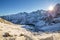 Winter mountains. Morning landscape of Tatra mountains with bright sun with sunbeams. Mountains hills covered with snow illuminate