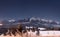 Winter mountains at night. Starry night over snowy summits of mountain range