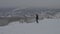 Winter mountains panorama. Skier and snowboarder silhouette high in the mountains. skier, snowy hills and sun in front