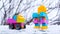 Winter new year children toy car and robot. toys in the snow on the street. Cristmas presents
