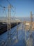 Winter northern short day. Low polar sun. Railway station or train station. Railway in the snow. Trains, freight cars and