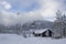 Winter norwegian landscape in the morning with cottage house and forest in low clouds near Hemsedal Buskerud Norway