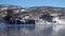 Winter norwegian panorama with the houses on a sea shore