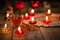 Winter ornamental decoration with burning candles on wooden rustic table.