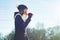 Winter outdoor portrait of young girl screaming in a megaphone paper cup, copy space