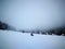 Winter over the village with slope, snow, trees and houses