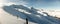 Winter panorama with fence posts and fresh powder of the ridge leading to the Hochwang peak near Chur