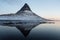 Winter panorama mirror reflection of Kirkjufell mountain blue hour sunrise Grundarfjordur Snaefellsnes Peninsula Iceland