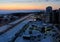 Winter panorama overlooking Sportivnaya Street, the embankment of the frozen Volga River, residential buildings and the Vega Hotel