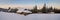 Winter panorama. Wooden houses of shepherds under the snow. Morn