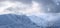 Winter panoramic. Landscape of high mountains with snow white peak. Forest. Lawn covered with snow. Evergreen trees in the